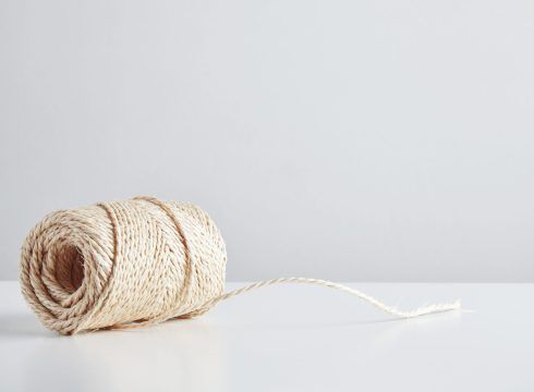 Hasp of craft rope isolated in side of white table